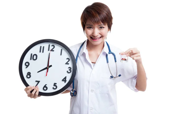 Uśmiech młodych azjatyckich kobiet lekarza z zegarem i pigułki. — Zdjęcie stockowe