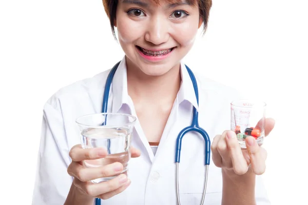 Young Asian female doctor with water and medicine. — Stock Photo, Image