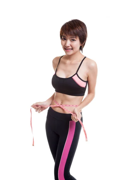 Beautiful Asian healthy girl measuring her waist. — Stock Photo, Image