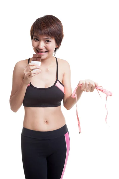 Beautiful Asian healthy girl with chocolate and measuring tape. — Stock Photo, Image