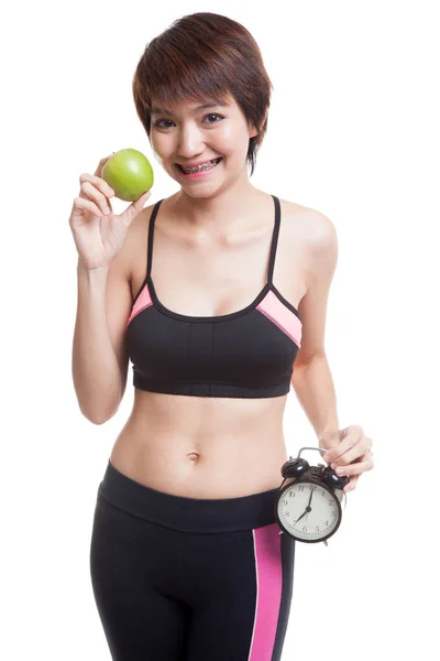 Beautiful Asian healthy girl with clock and apple. — Stock Photo, Image