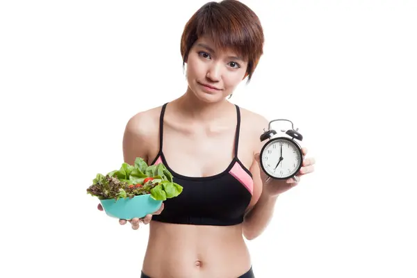 Beautiful Asian healthy girl with clock and salad. — Stock Photo, Image