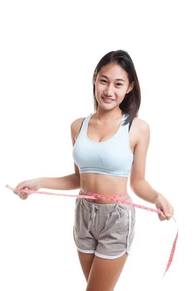 Beautiful Asian healthy girl measuring her waist. — Stock Photo, Image