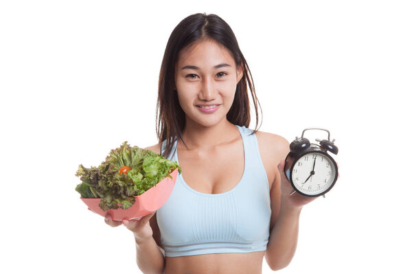 Beautiful Asian healthy girl with clock and salad.