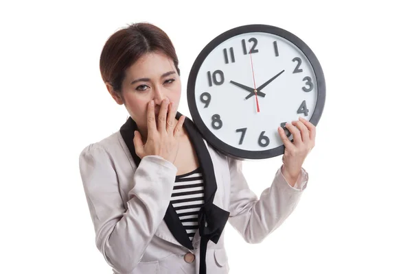 Sleepy young Asian business woman with a clock in the morning. — Stock Photo, Image