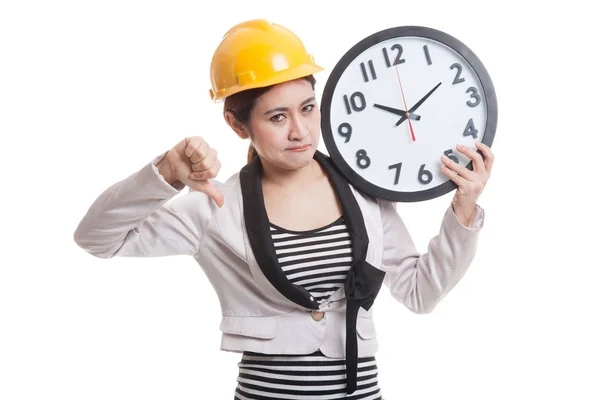 Asian engineer woman thumbs down with a clock. — Stock Photo, Image