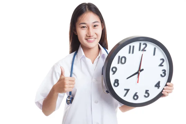 Young Asian female doctor thumbs up with a clock. — Stock Photo, Image