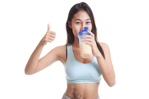 Beautiful Asian healthy girl show thumbs up  drink whey protein. — Stock Photo, Image