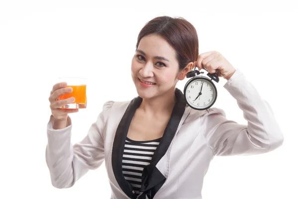 Asian woman with a clock drink orange juice. — Stock Photo, Image