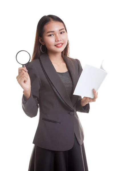 Asian business woman with a book and magnifying glass. — Stock Photo, Image