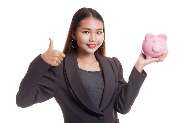 亚洲业务的女人竖起大拇指与猪硬币银行. — 图库照片