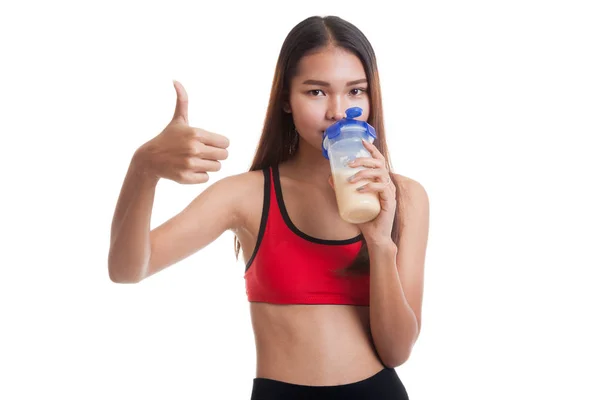 Beautiful Asian healthy girl show thumbs up  drink whey protein. — Stock Photo, Image