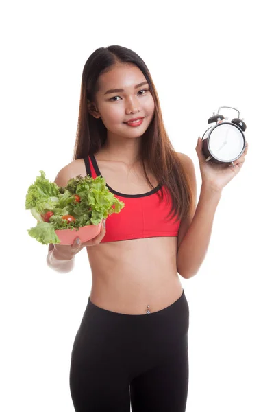 Beautiful Asian healthy girl with clock and salad. — Stock Photo, Image