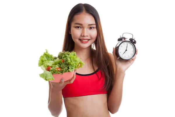 Beautiful Asian healthy girl with clock and salad. — Stock Photo, Image