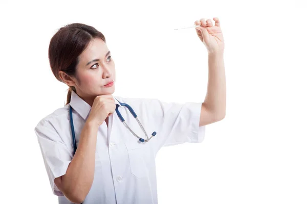 Young Asian female doctor  think with thermometer. — Stock Photo, Image