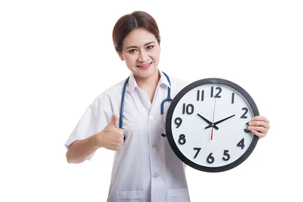 Young Asian female doctor thumbs up with a clock. — Stock Photo, Image