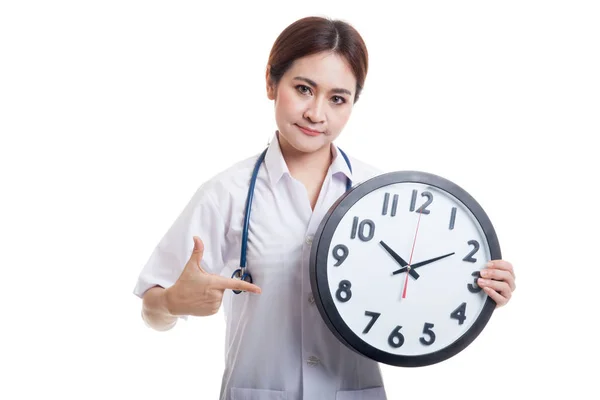 Joven asiática mujer médico punto a un reloj . —  Fotos de Stock