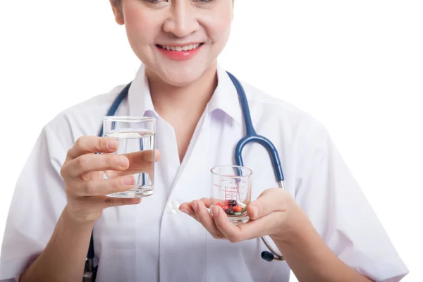 Young Asian female doctor with water and medicine. — Stock Photo, Image