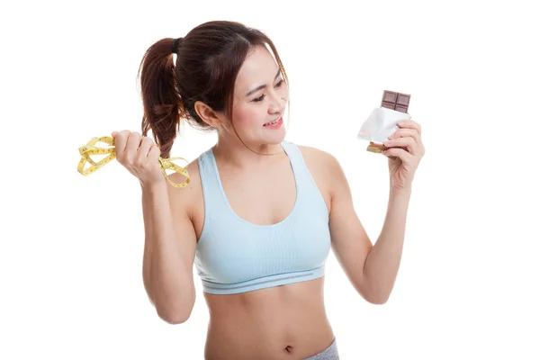 Beautiful Asian healthy girl with chocolate and measuring tape. — Stock Photo, Image