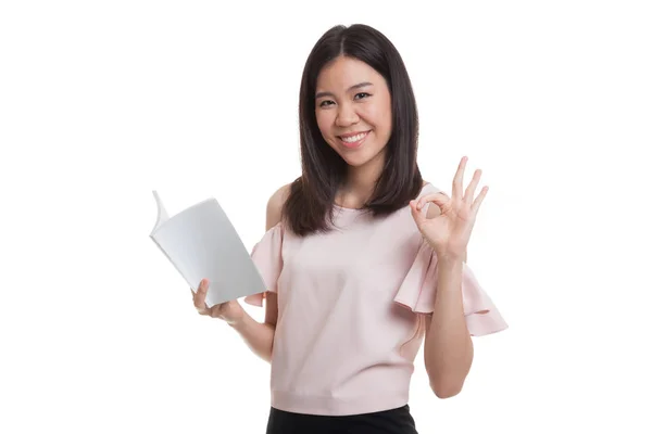 Young Asian business woman show OK with a book. — Stock Photo, Image