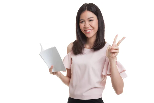 Young Asian business woman show victor sign with a book. — Stock Photo, Image