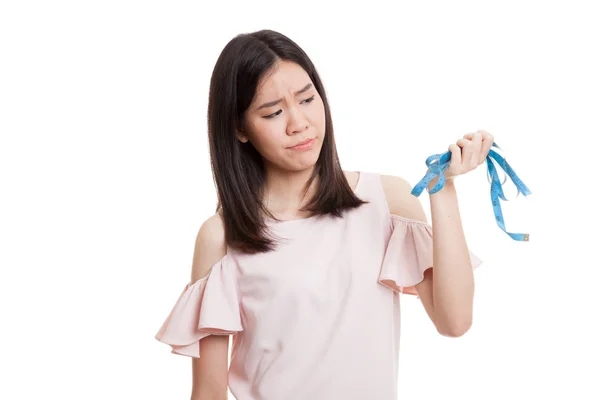 Unhappy young Asian business woman with measuring tape. — Stock Photo, Image