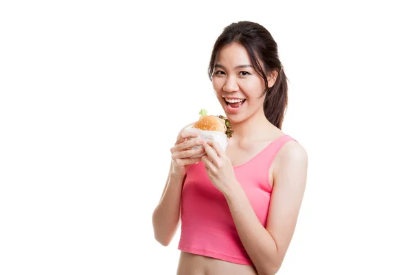 Mooie Aziatische gezond meisje geniet van eten hamburger. — Stockfoto