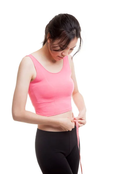 Beautiful Asian healthy girl measuring her waist. Stock Image
