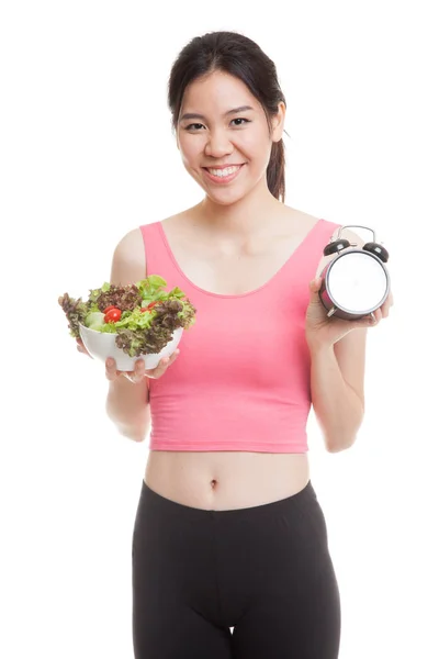 Beautiful Asian healthy girl with clock and salad. — Stock Photo, Image