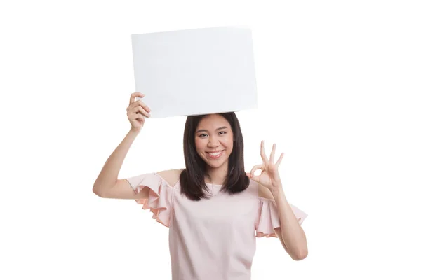 Young Asian business woman show OK with  white blank sign. Royalty Free Stock Images