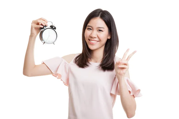 Young Asian business woman show victory sign with a clock. — Stock Photo, Image