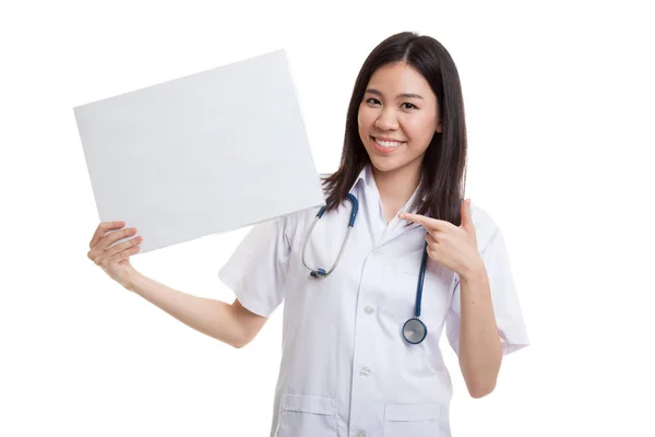 Young Asian female doctor point to a blank sign. — Stock Photo, Image