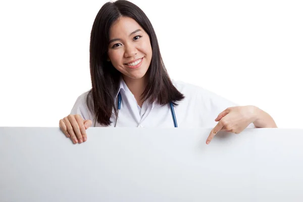 Young Asian female doctor point down to blank sign. — Stock Photo, Image