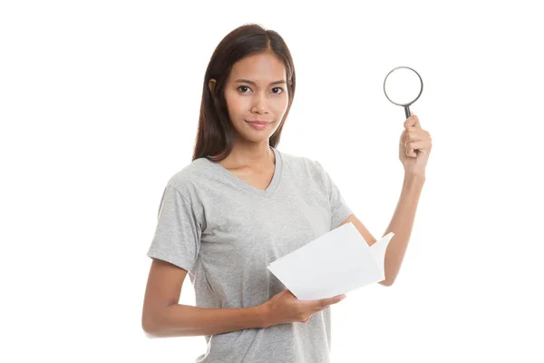Asian woman with a book and magnifying glass. — Stock Photo, Image
