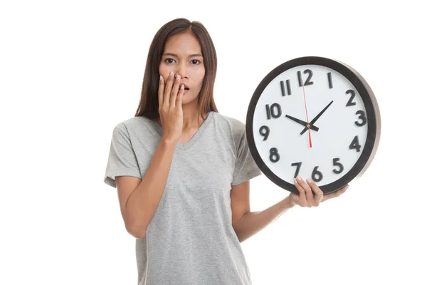 Sleepy young Asian woman with a clock in the morning. — Stock Photo, Image