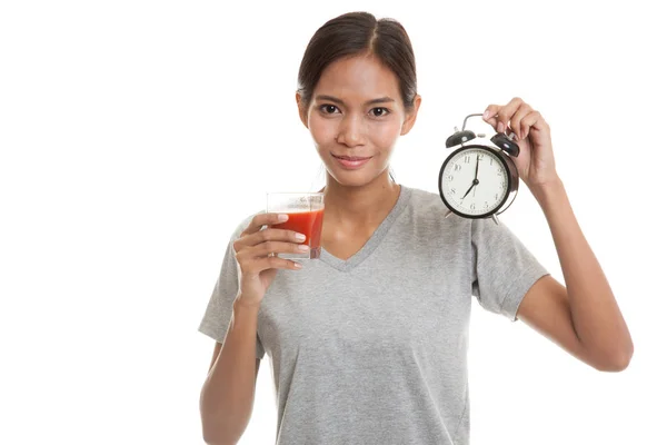 Young Asian woman with tomato juice and clock. — Stock Photo, Image