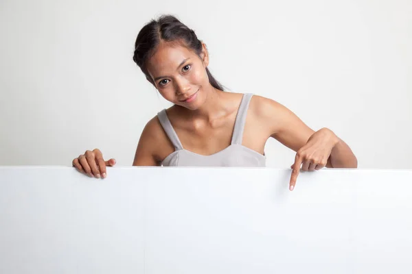 Young Asian woman point to a  blank sign. — Stock Photo, Image