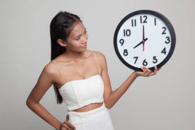 Saati olan genç Asyalı kadın..