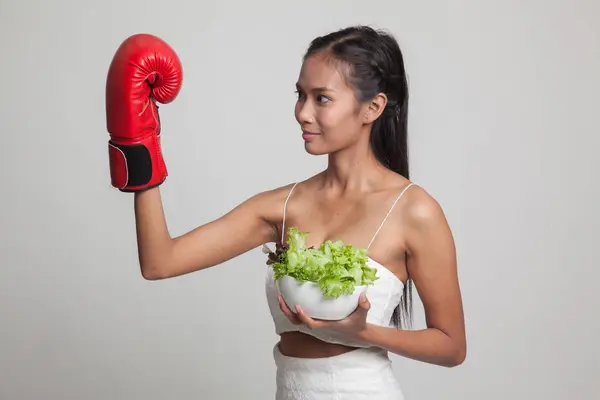 Young Asian woman with boxing glove and salad. — Stock Photo, Image