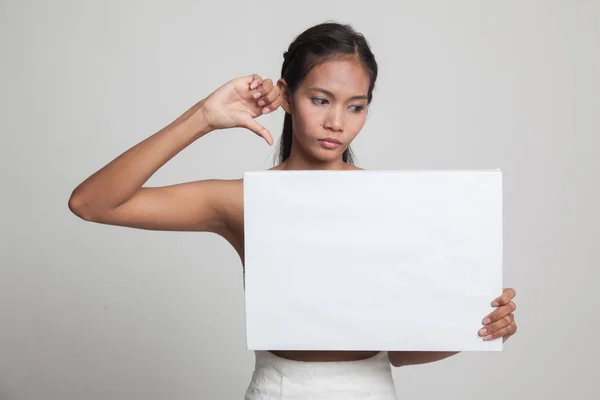 Young Asian woman show thumbs down with white blank sign. — Stock Photo, Image