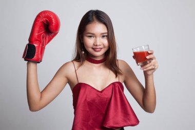 Domates suyu ve Boks eldiveni ile genç Asyalı kadın.