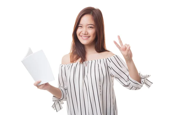 Young Asian woman show victor sign with a book. — Stock Photo, Image