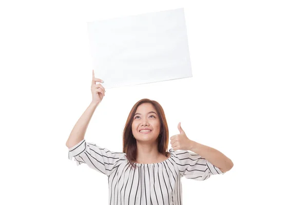 Young Asian woman show thumbs up with white blank sign. Royalty Free Stock Photos