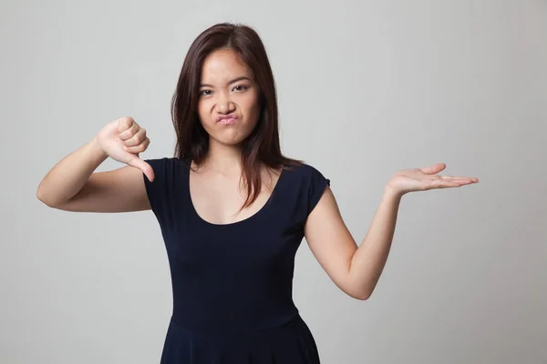 Young Asian woman show palm hand and thumbs down. — Stock Photo, Image