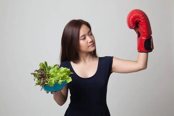 Ung asiatisk kvinna med boxning handske och sallad. — Stockfoto