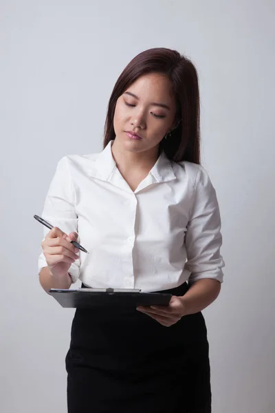 Junge asiatische Geschäftsfrau mit Stift und Klemmbrett. — Stockfoto