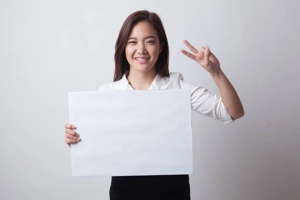 Unga asiatiska affärskvinna Visa seger tecken med tomma tecken. — Stockfoto
