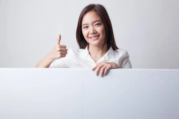 Young Asian woman show thumbs up with blank sign. — Stock Photo, Image