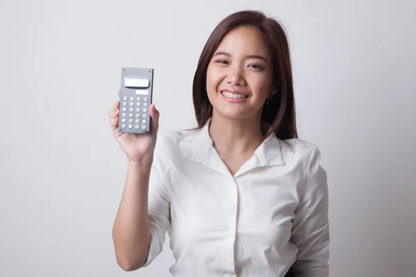 Азиатка улыбается с калькулятором . — стоковое фото