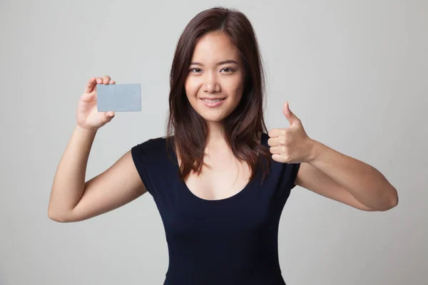 Young Asian woman thumbs up with a blank card. — Stock Photo, Image